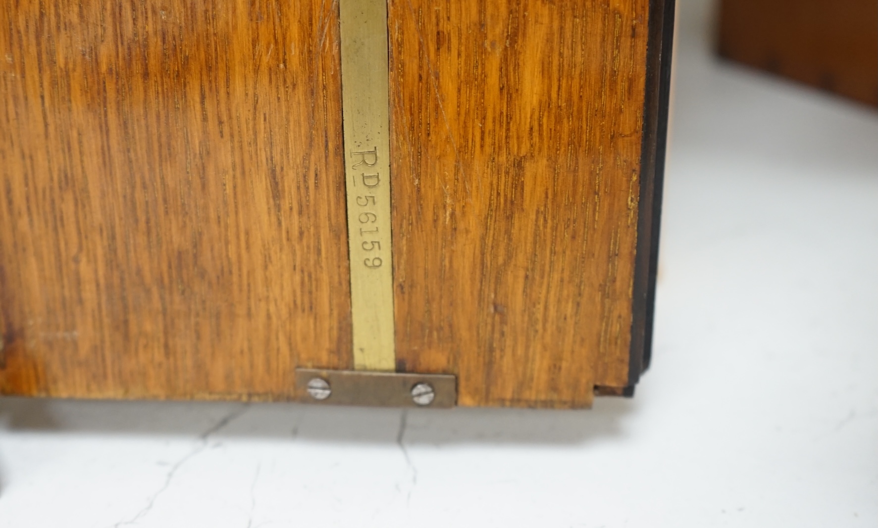 A Victorian oak cigar cabinet modelled as a safe, with brass coat of arms mounts, 30cm wide, 31cm high. Condition - fair